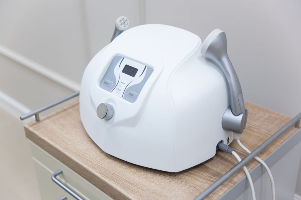 Close-up of a modern medical face massager on a sterile cabinet, essential for healthcare settings.