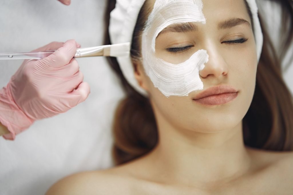 A serene spa facial treatment with a skincare mask being applied.